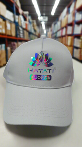 white cap with colorful logo and text on a warehouse floor